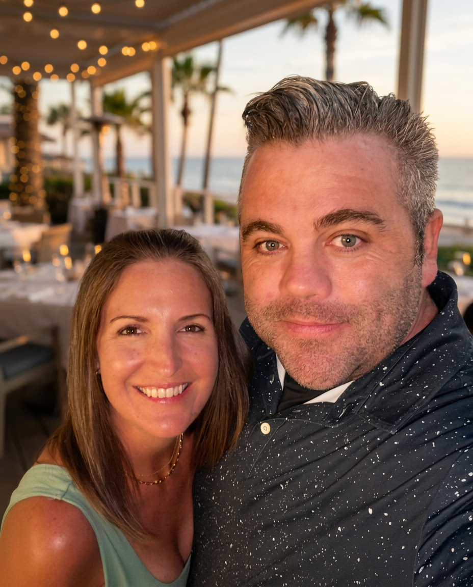 Jeremy, founder of First Response Voyages, and his wife at a coastal restaurant at golden hour